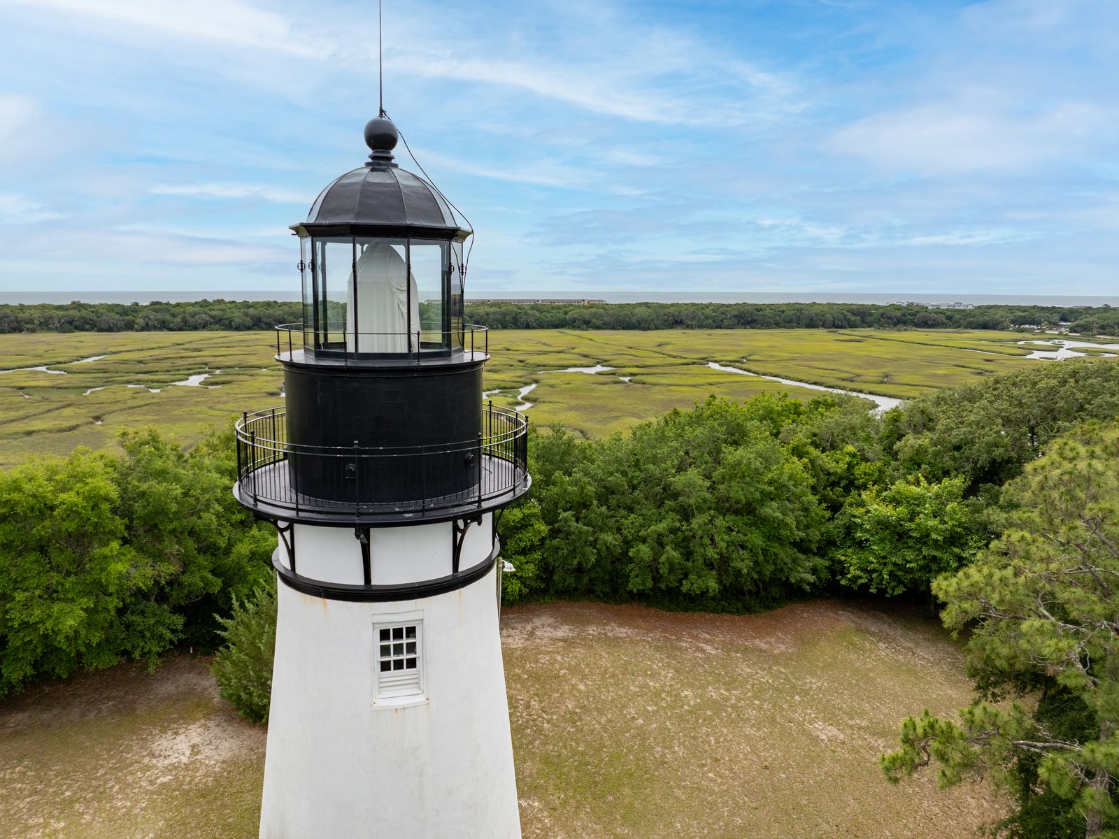 Amelia Island lighthouse with tidal marsh and Atlantic Ocean in the background