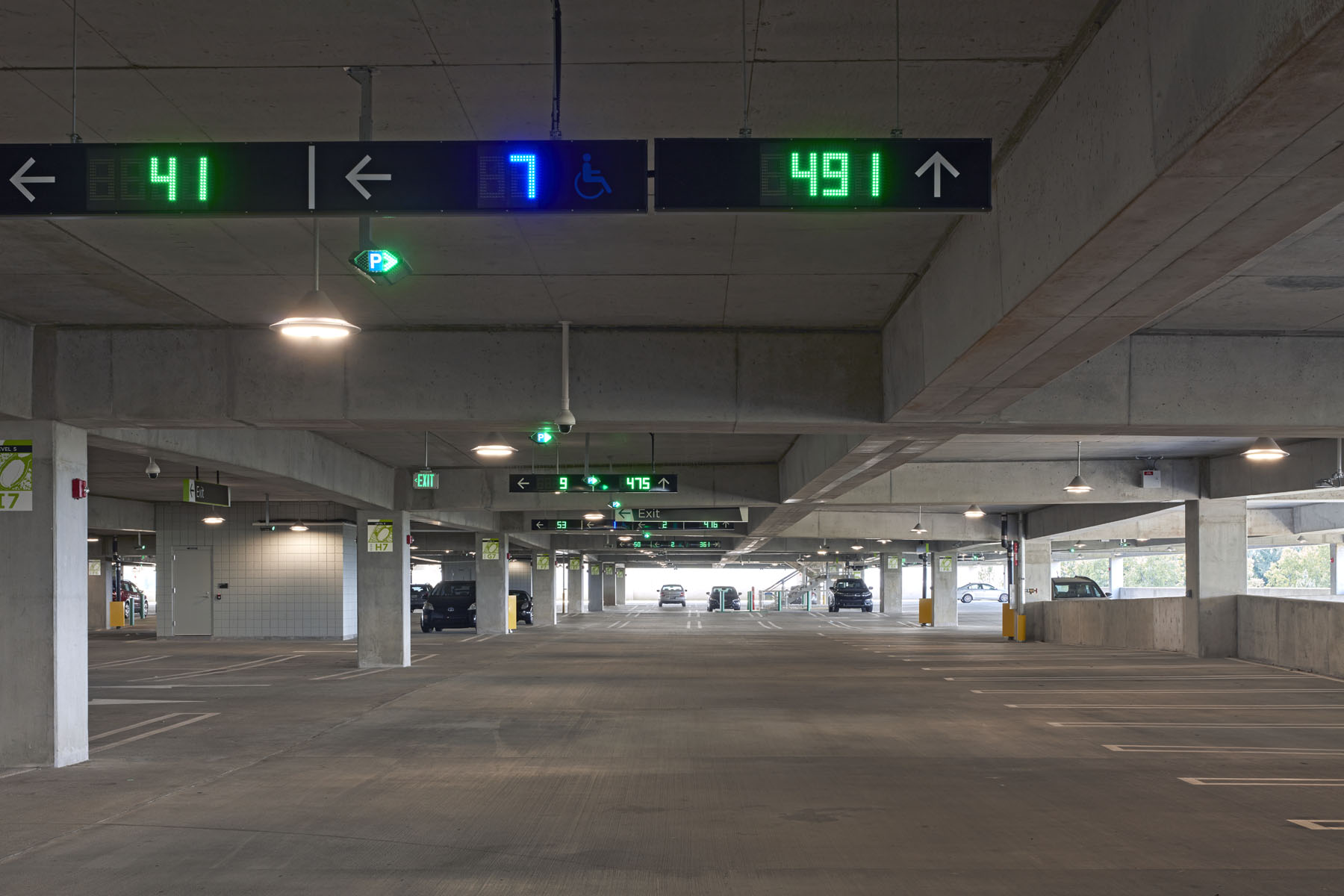 Interior of ATL West Deck showing parking spaces and a sign displaying real-time space availability